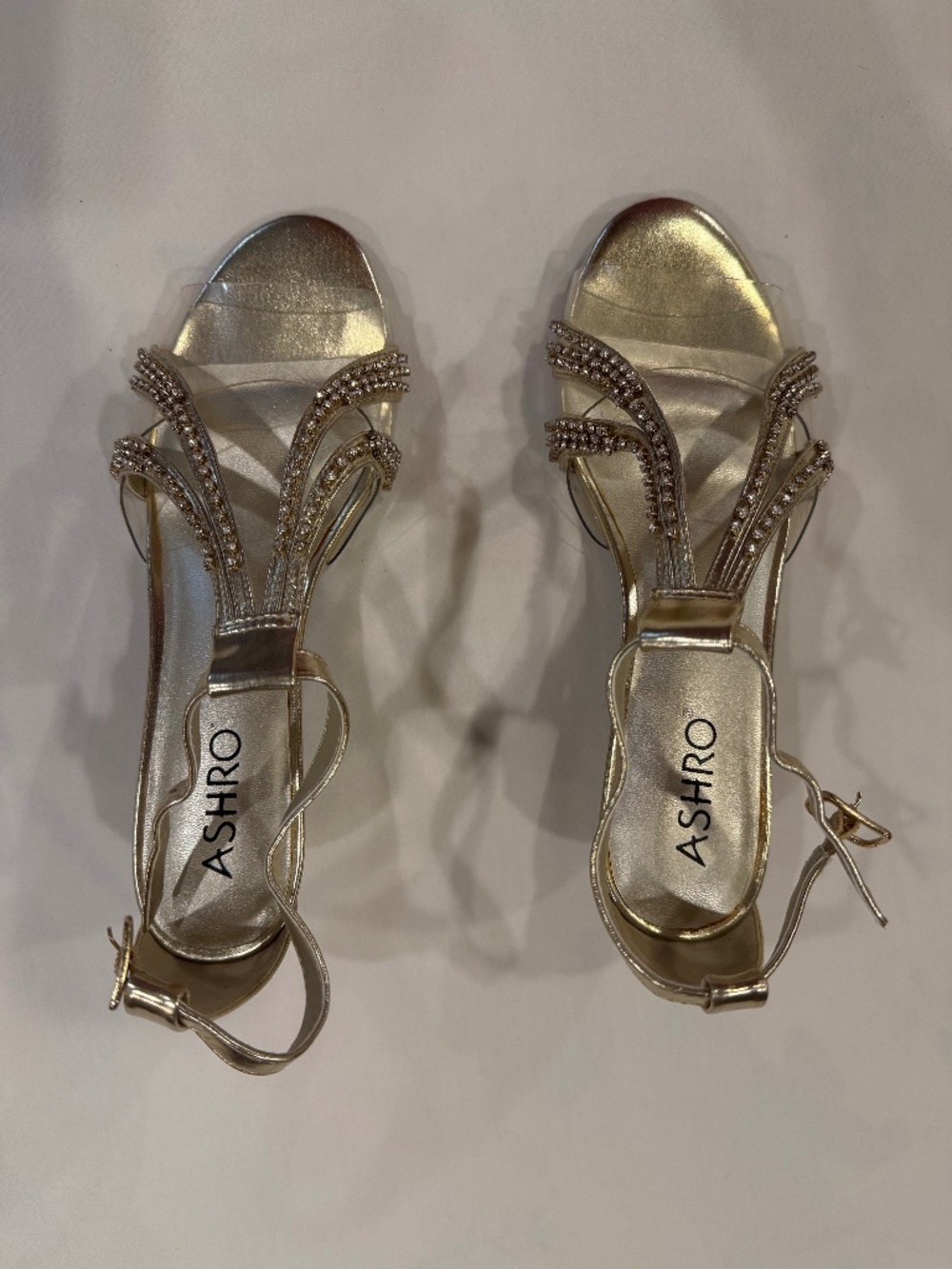 Gold and clear evening shoes with low heel